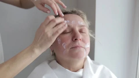 Getting vitamins through the skin, applying cream to the face. Anti-aging facial Stock-Footage 222904585