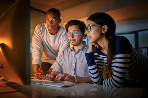 Getting work done together. Shot of computer programmers working together lat Stock-Fotos