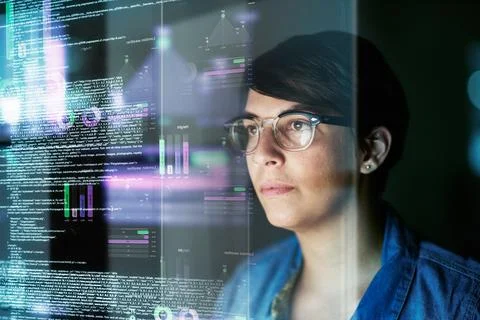 Getting to work on her code. a young computer programmer looking through data. Stock Photos