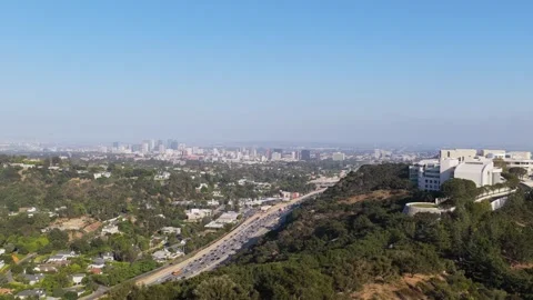 Getty Center architecture overlooking hazy Los Angeles skyline with heavy traffi Stock Footage 336635265