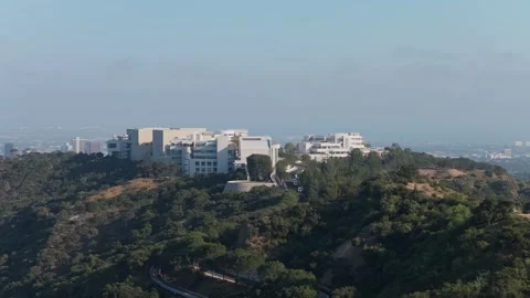 Getty Center museum orbiting over Santa Monica Mountains with Los Angeles citysc Stock Footage 336635273