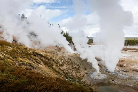 Geyser basin at Yellowstone exploding white smoke Stock Photos
