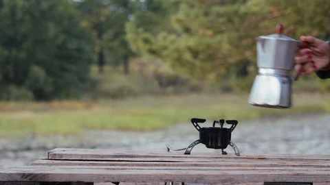 A geyser coffee maker stands on a burner against the backdrop of beautiful Stockbeeldmateriaal 123993466