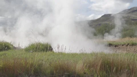 Geysers unleash Earth's energy in dramatic dance of steam and water Stock Footage 255694591