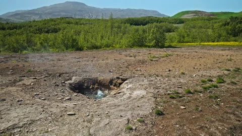 Geysir erupts with force under a clear blue sky in Haukadalur Valley, Iceland. Stock Footage 293638171