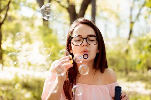 Ggirl blowing soap bubbles Stock Photos
