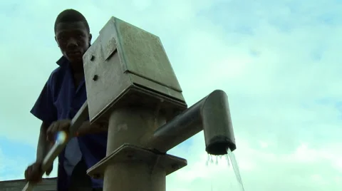 GHANA UP ANGLE OF MAN PUMPING BOREHOLE WATER Stock Footage 57830249