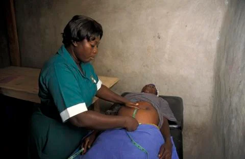 Ghana midwife measuring stomoch of pregant woman Stock Photos