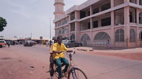 Ghana mosque with Cyclists Stock Footage 37613945