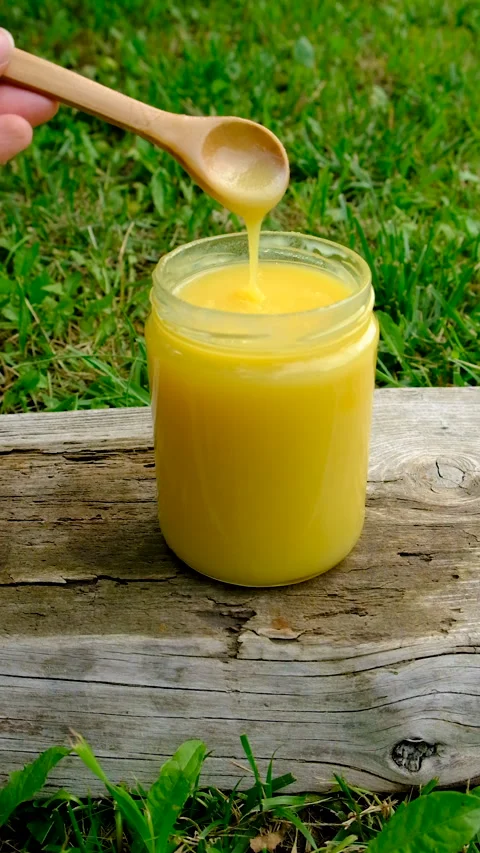 Ghee in a jar in a meadow. Selective focus. Stock Footage 319848020