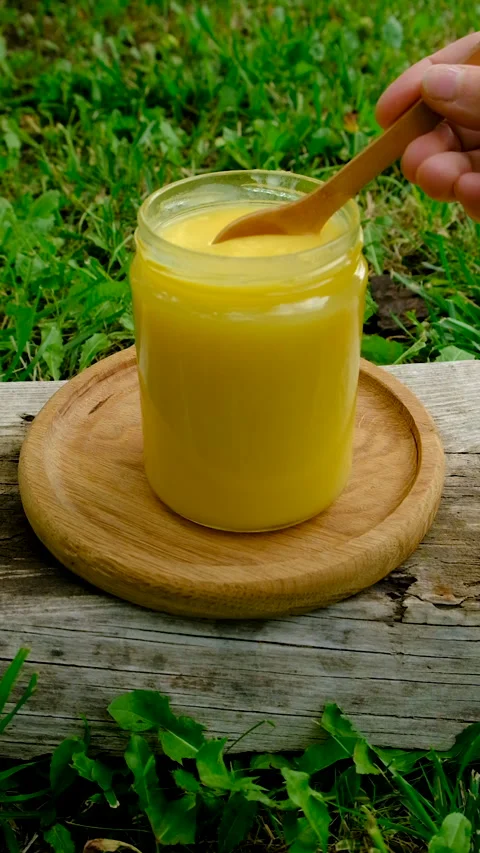 Ghee in a jar in a meadow. Selective focus. Stock Footage 319848670
