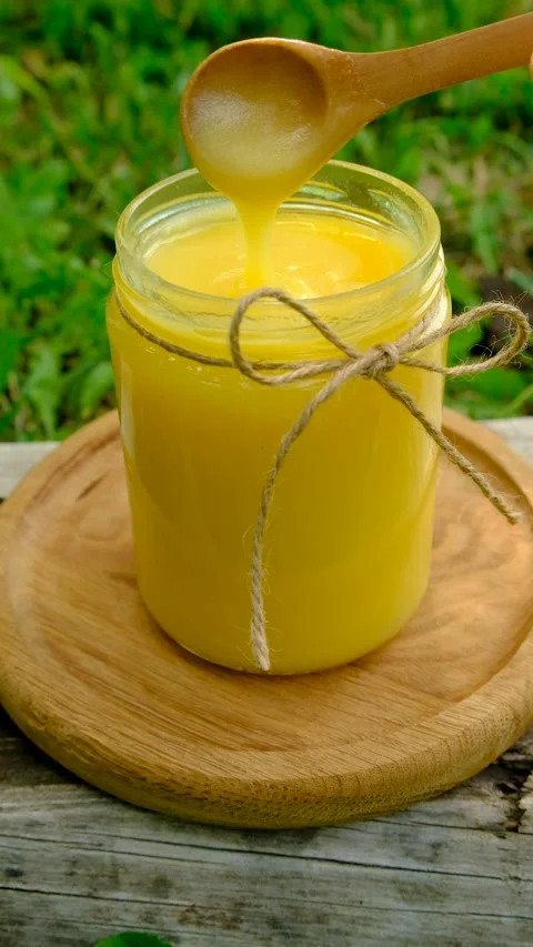 Ghee in a jar in a meadow. Selective focus. Stock Footage 319848679
