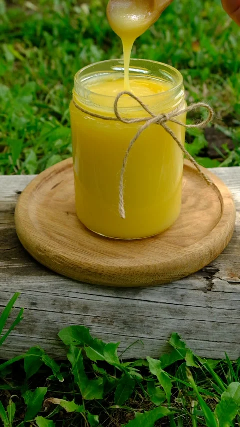 Ghee in a jar in a meadow. Selective focus. Stock Footage 319849051