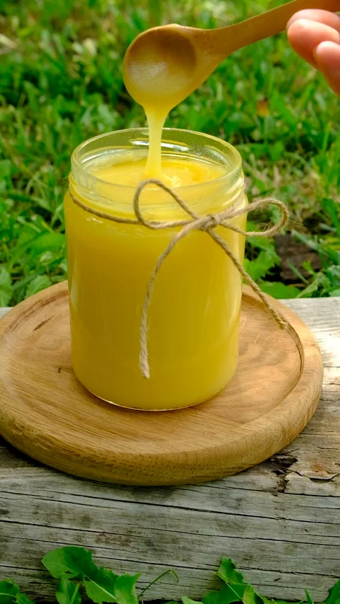 Ghee in a jar in a meadow. Selective focus. Stock Footage 319849056