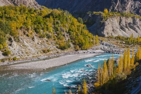 Ghizer river flowing through forest in Gahkuch, Gilgit Baltistan, Pakistan. Stock Photos