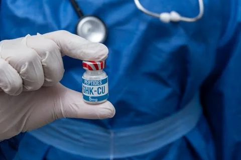GHK-CU peptide vial held by a clinical professional for medical research Stock Photos