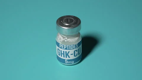 GHK-CU peptide vial on teal background with dramatic shadow Stock Footage 344999949