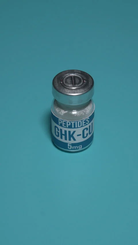 GHK-CU peptide vial on teal background with dramatic shadow Stock-Footage 345009736