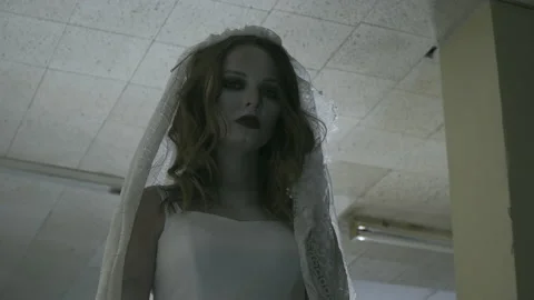 The ghost of the bride stands in a dark corridor and looks Stock-Footage 155905694