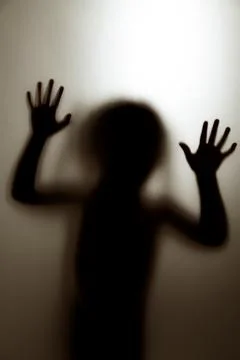 Ghost concept shadow of a child behind the matte glass blurry hand and body Foto stock