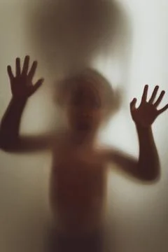 Ghost concept shadow of a child behind the matte glass blurry hand and body 스톡 사진