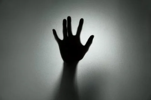 Ghost concept shadow of hand behind the matte glass blurry hand and body Stock Photos