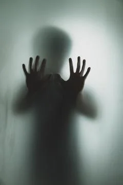 Ghost concept shadow of a men behind the matte glass blurry hand and body Stock Photos