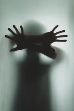 Ghost concept shadow of a men behind the matte glass blurry hand and body Foto stock