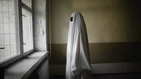 Ghost in costume standing near window abandoned house Stock Footage 313495782