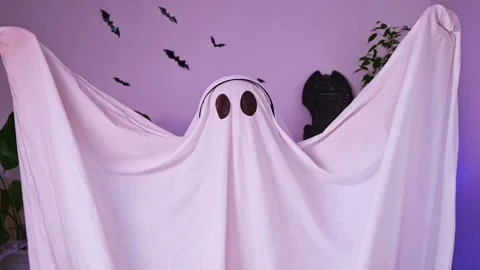A ghost is dancing at a Halloween party. The ghost listens to music with Stock Footage 219633958
