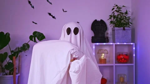 Ghost eats Halloween sweets. ghost eats worms, candy, sweets or muck, trick or Stock Footage 218614032