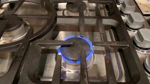 Ghost face marshmallow roasting over a gas stove catches on fire for Halloween Stock Footage 140673427