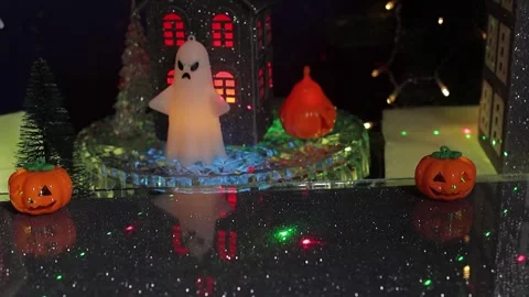 A ghost glides past a gray, rotating house surrounded by glowing ghost figures Stock Footage 346601645