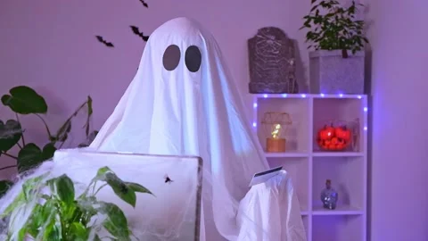 Ghost makes order from computer Halloween. Ghost pays online purchase credit Stock Footage 231186508