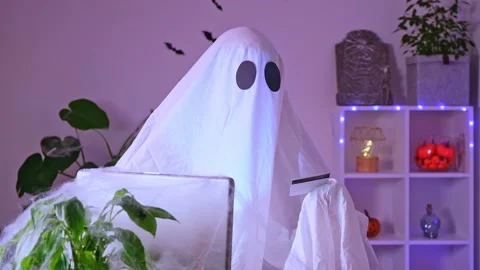 Ghost makes order from computer Halloween. Ghost pays online purchase credit Stock Footage 233470151