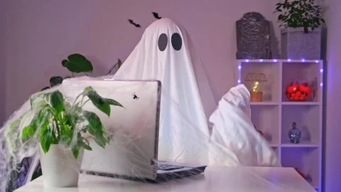 Ghost makes order from computer Halloween. Ghost pays online purchase credit Stock Footage 235913443