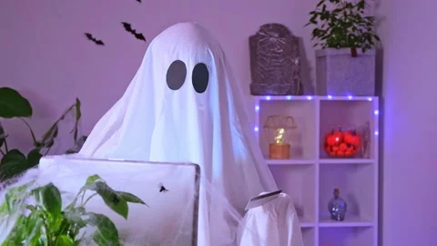 Ghost makes order from computer Halloween. Ghost pays online purchase credit Stock Footage 235914314