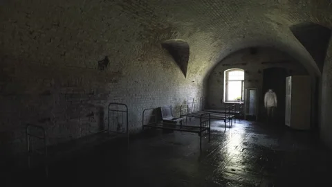 A ghost of a man wanders in an old abandoned psychiatric hospital. Stock Footage 112952490