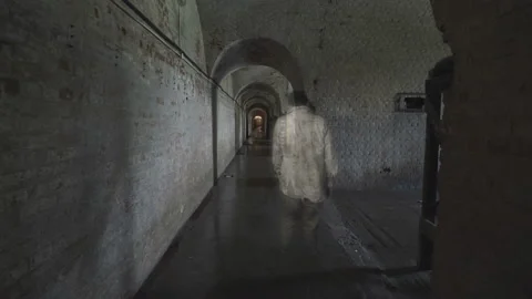 A ghost of a man wanders through the gloomy corridors of old dungeons. Stock Footage 112951927
