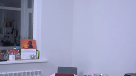 Ghost or invisible man in pink pajamas stands in middle of apartment and starts Stock Footage 141178790