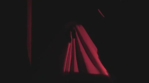 Ghost in red light in the attic close up.Ghost costume for October holidays. Stock Footage 308961972