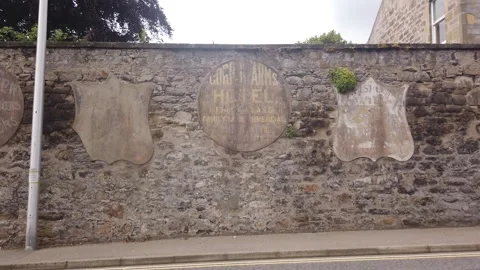 Ghost signs of old advertisements on a stone wall in Elgin, Scotland. Stock Footage 309175188