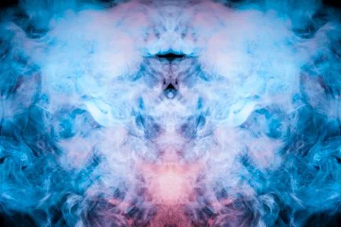 The ghostly drawing of an alien image in puffs of blue violet smoke on a blac Stock Photos