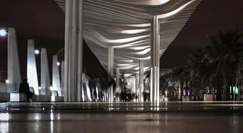 Ghostly figures walking round Malaga marina Stockfoto's