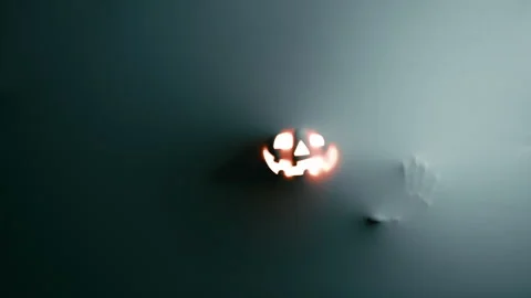 Ghostly Hands and Glowing Jack O Lantern Behind Fabric Stock Footage 317622874