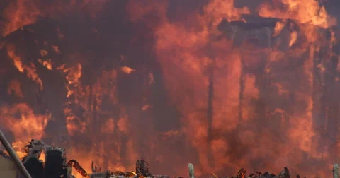 The ghostly silhouette of house support structures engulfed in flames Stock Footage 59528509
