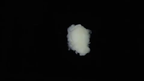 Ghostly white cloud emerges from black Stock Footage 72475296