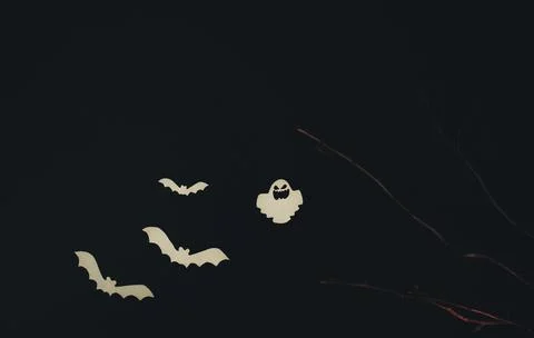 Ghosts and paper bats, tree branches on a black background Stock Photos