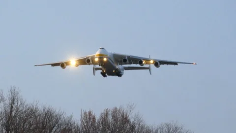Giant Antonov AN-225 final approach and passing shot at sunset Stock Footage 129586124