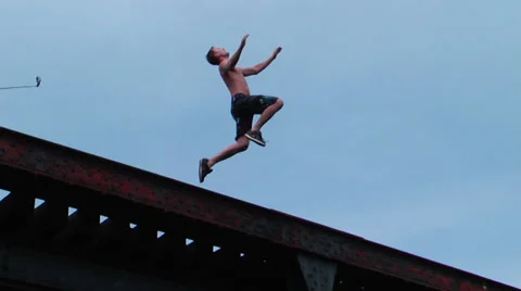 Giant backflip into water from train bridge slow motion and regular speed Stock Footage 27693972